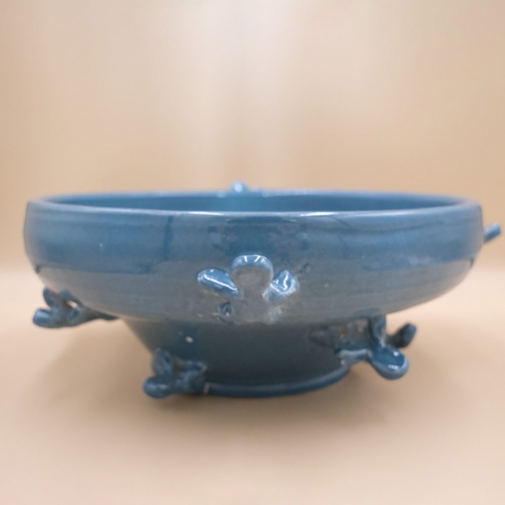 Ascendance, a blue ceramic bowl with climbing figures