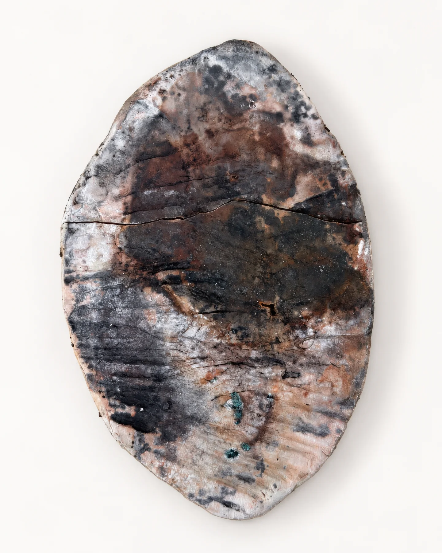 Saggar Piece 1: a ceramic slab with dark carbon marks and pale, fire-patterned surfaces.