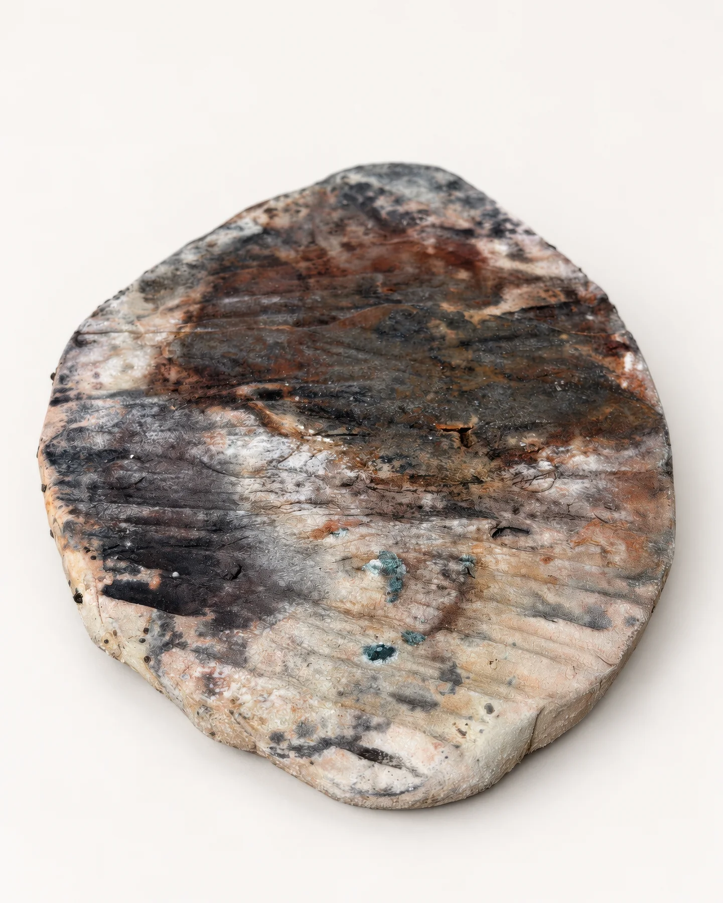 Saggar Piece 1: a ceramic slab with dark carbon marks and pale, fire-patterned surfaces.